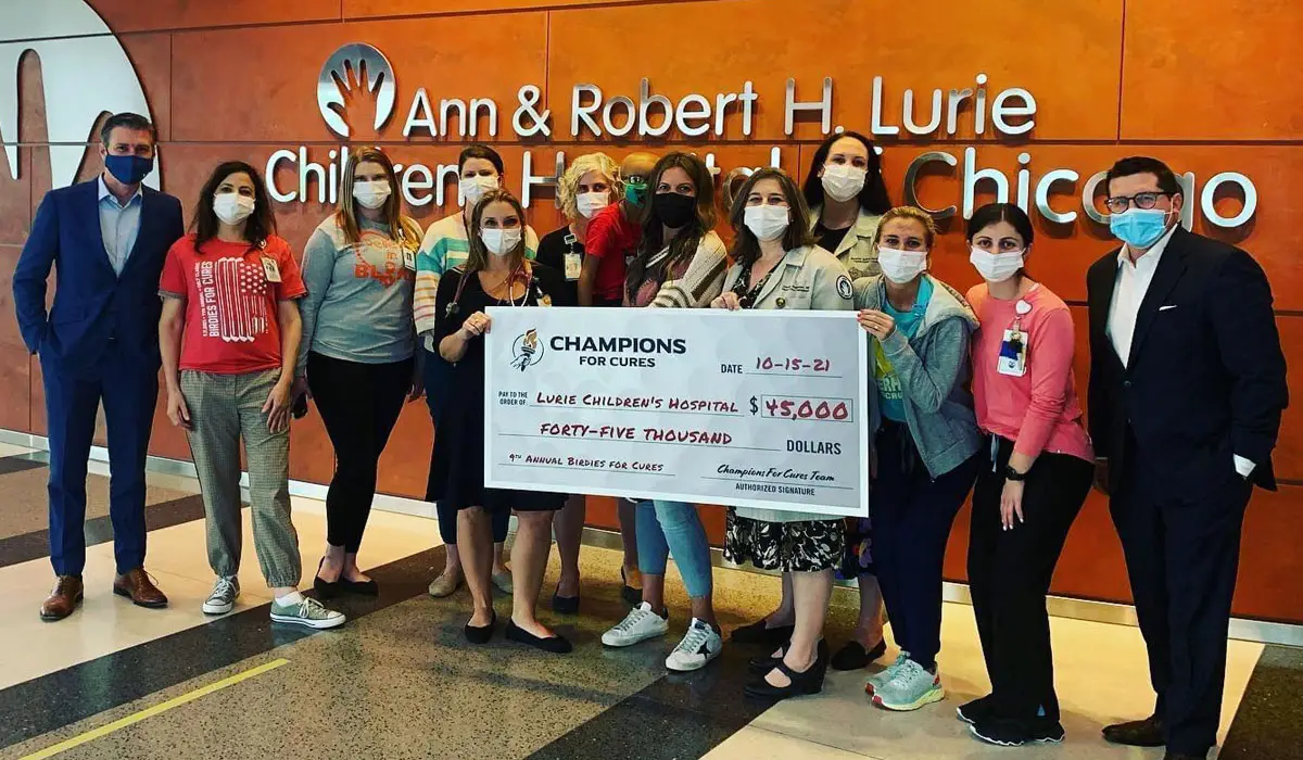 Cancer Costs: a clinical trials organization receiving a donation check