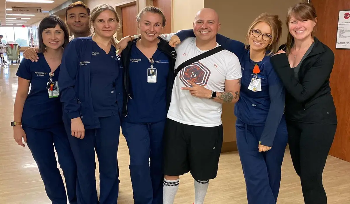A cancer patient with his supportive nurses and healthcare team.